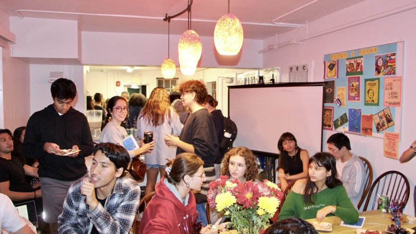 Students, staff, and faculty are gathered in La Casa